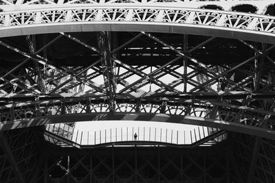 Low angle view of man standing on eiffel tower