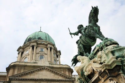 Low angle view of equestrian statue in front of buda castle
