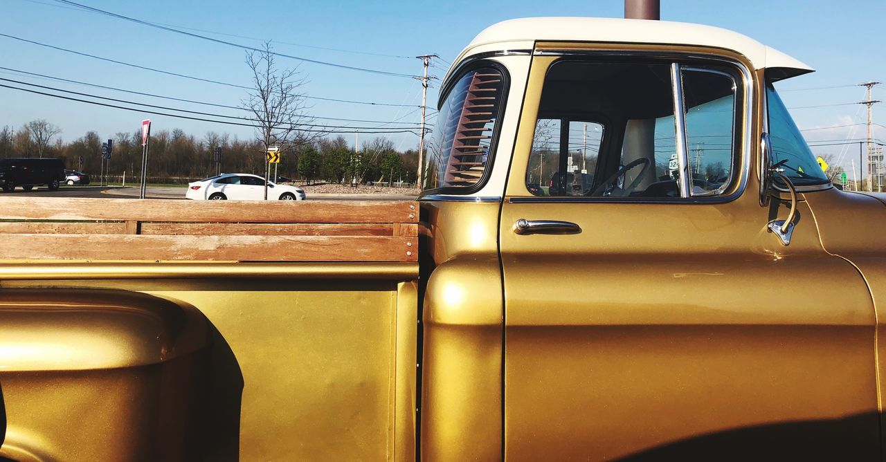 mode of transportation, land vehicle, transportation, motor vehicle, car, day, glass - material, nature, no people, sunlight, road, retro styled, sky, vintage car, stationary, side-view mirror, outdoors, reflection, city