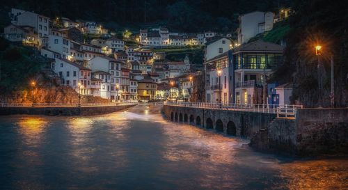 Illuminated buildings in city at night