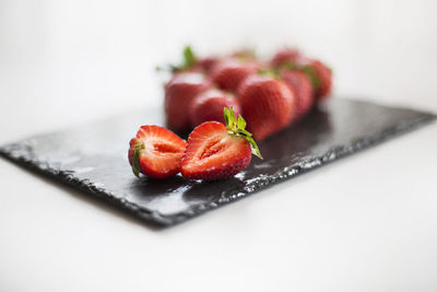 Close-up of strawberry on table against white background