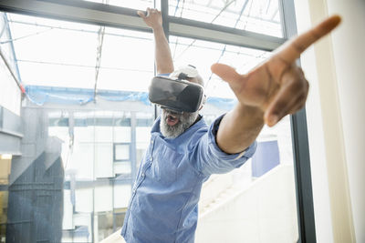 Businessman wearing vr glasses at the window