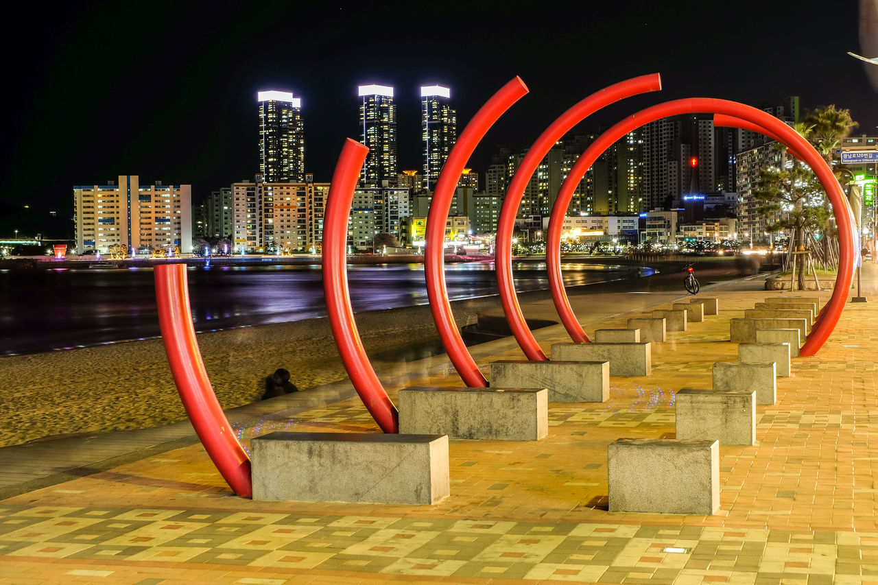 ILLUMINATED BUILDINGS AGAINST SKY AT NIGHT