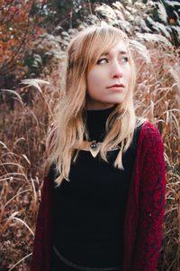 Close-up portrait of young woman standing outdoors