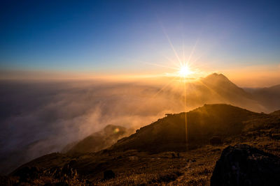 Scenic view of mountains against sky during sunset