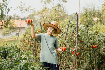 Woman standing on field against plants