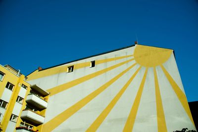 Low angle view of building against clear blue sky