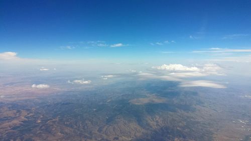 Aerial view of landscape against blue sky