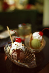 Close-up of ice cream in containers on table