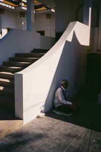 Man sitting on book in building