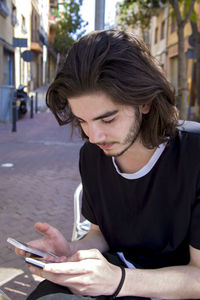 Close-up of young woman using mobile phone