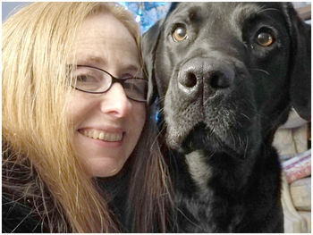 Portrait of smiling young woman with dog