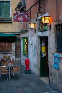 Chairs and tables in illuminated building at city. irish pub.