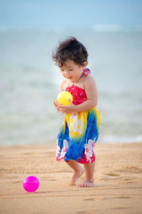 Cute girl with toy on beach