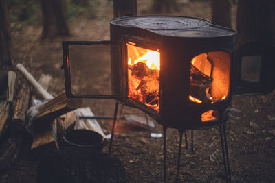 Winter camping. chopping wood with an axe and stoking the wood stove.