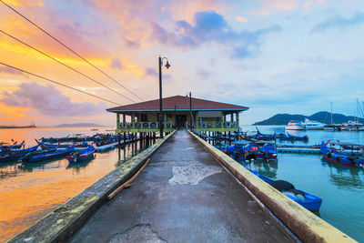 Jetty at sea against sky during sunset