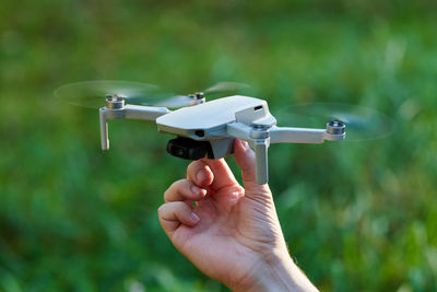 Quadcopter drone on operator hand. small drone land on hand. remote control air delivery and spy