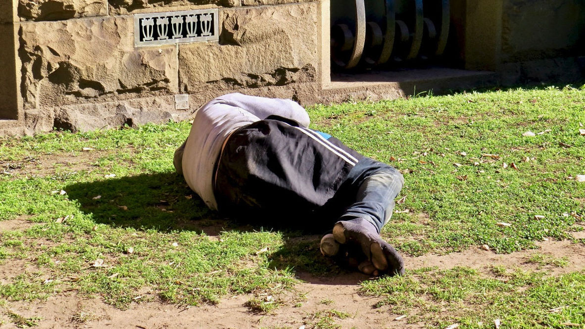 MIDSECTION OF MAN LYING ON LAND