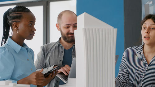 Portrait of smiling business colleagues working in office