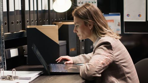 Young woman using laptop on table