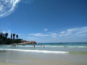 Scenic view of beach against blue sky
