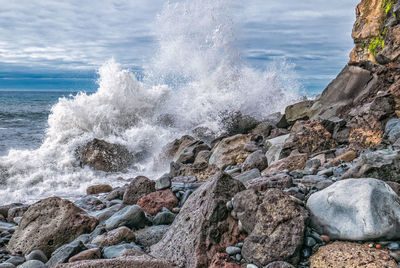 Waves splashing on rocks at shore