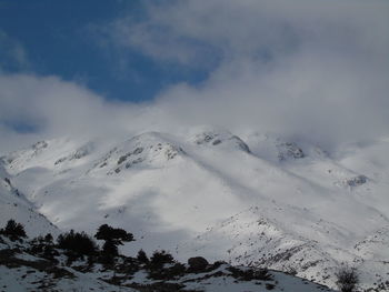 Low angle view of snowcapped mountain against sky