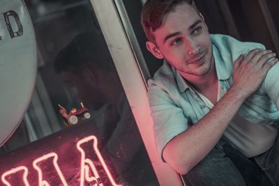 Portrait of young man holding camera