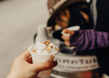 Close-up of woman holding ice cream cone