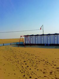 View of beach against clear blue sky