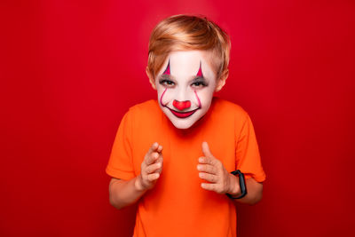 Portrait of a boy against red background