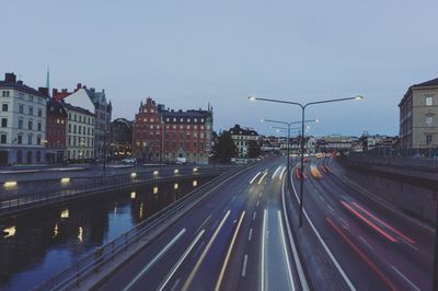 View of city street and buildings against sky