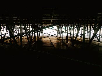 Silhouette bridge by building at night