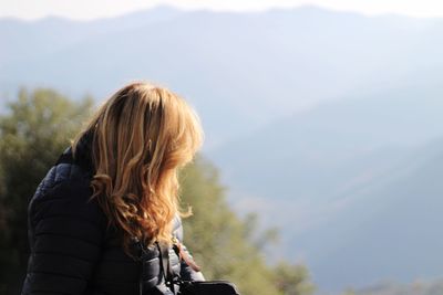 Woman standing against mountains