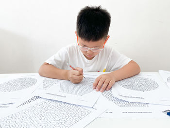 Full length of a boy sitting on table