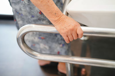 High angle view of man holding metal railing