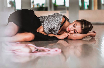 Portrait of woman lying down on floor