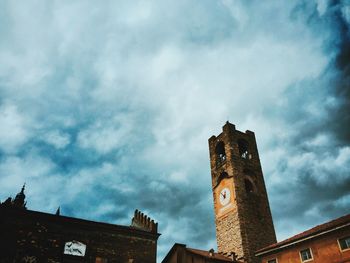 Low angle view of building against cloudy sky