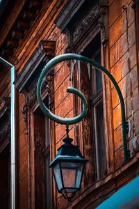 Low angle view of street light against building