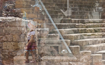 Man standing on staircase in city