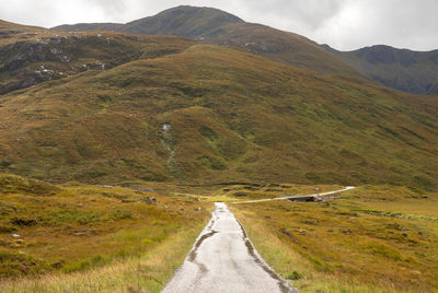 Wet path into the mountains with a landscape view in the scotthish highlands