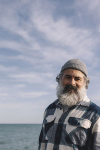 Close up of a cheerful modern bearded man walking outdoors