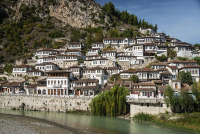 Buildings by river in town