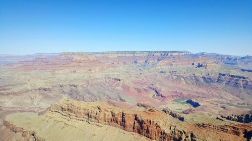 Scenic view of desert against blue sky
