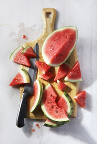 Watermelon sliced up on cutting board