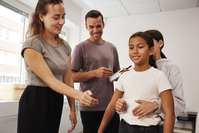 Teachers and children in first aid class