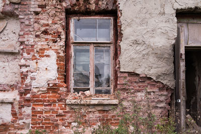 Damaged window of old building