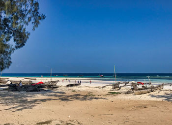 Scenic view of beach against clear blue sky