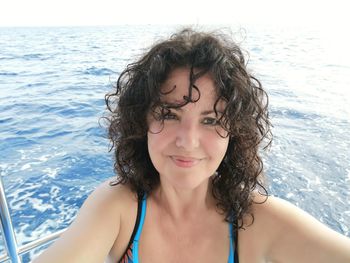 Portrait of smiling woman on boat against sea