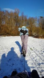 Rear view of woman on snow covered field